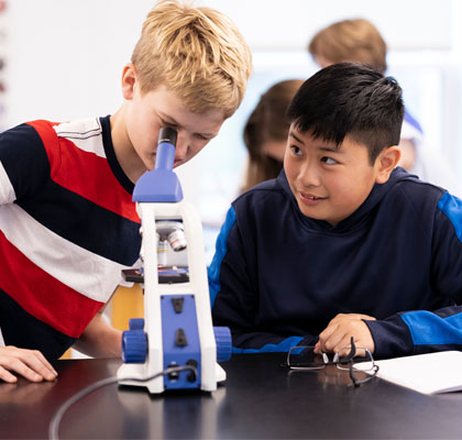 Two boys with microscopes