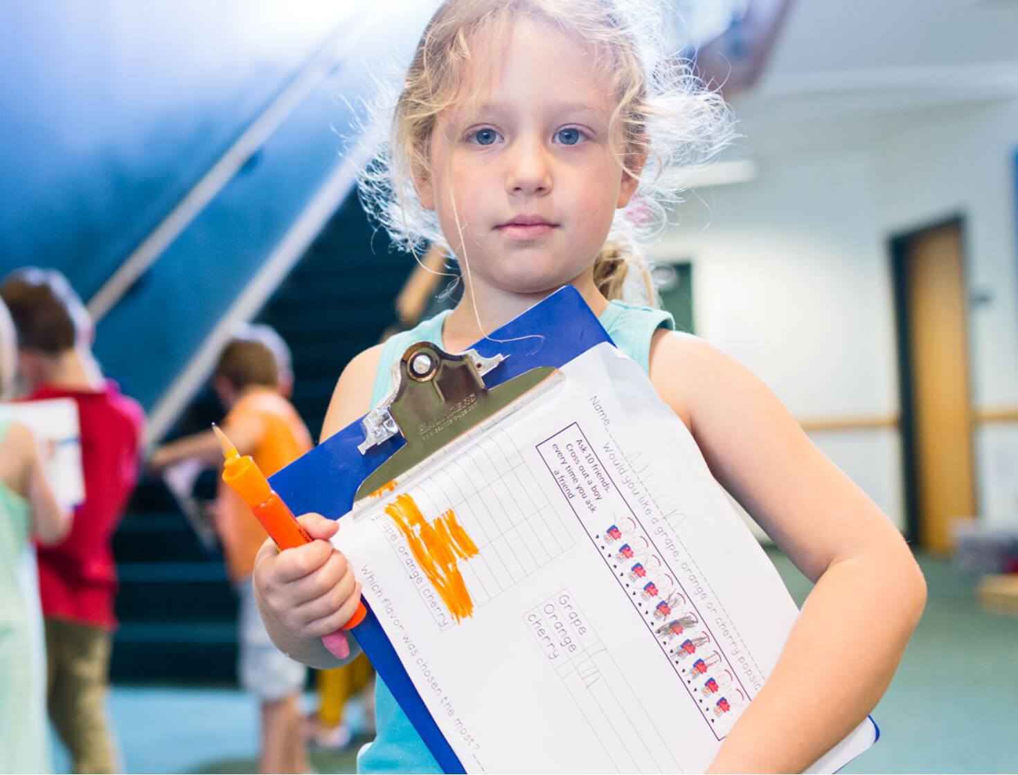 little girl holding a clipboard