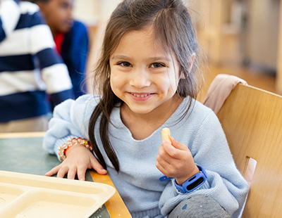 child smiling in dining hall