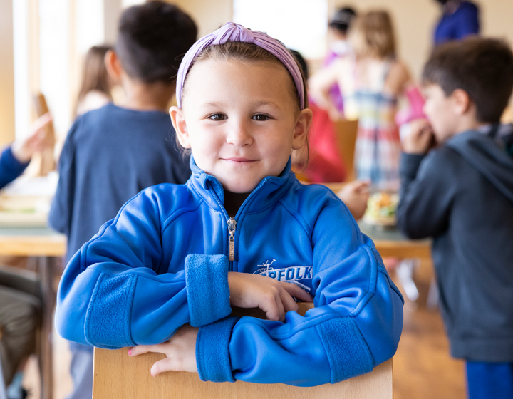 Little girl in blue shirt smiling