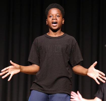 Boy singing on stage