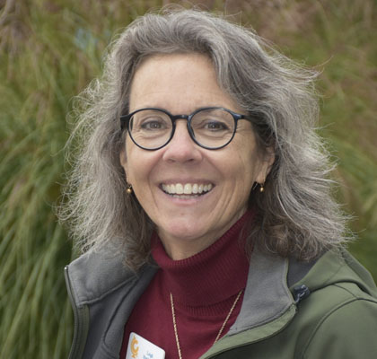 Woman in green coat and red shirt