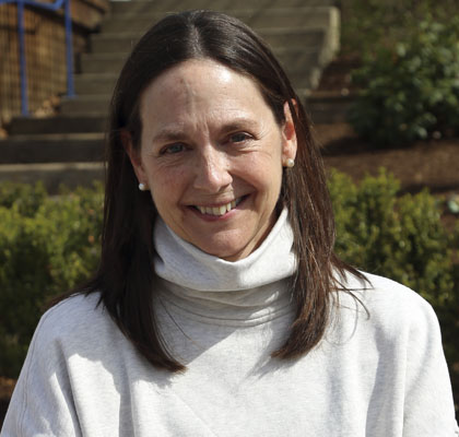 Woman in white turtle neck sweater