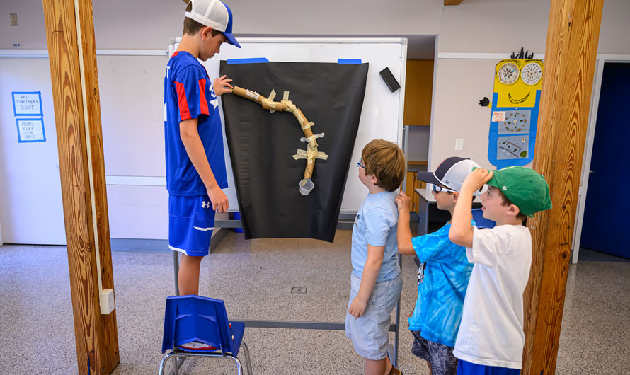 children looking at an art project