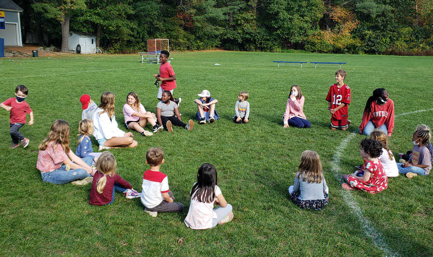 children sitting outside in a circle