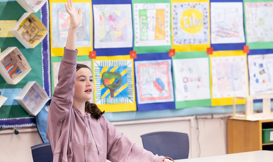 girl in class raising hand