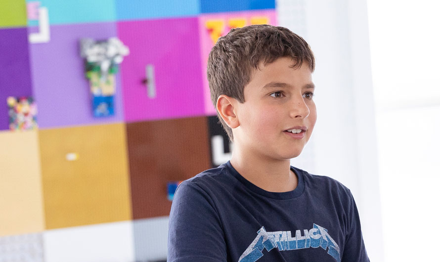 child in classroom with colorful background