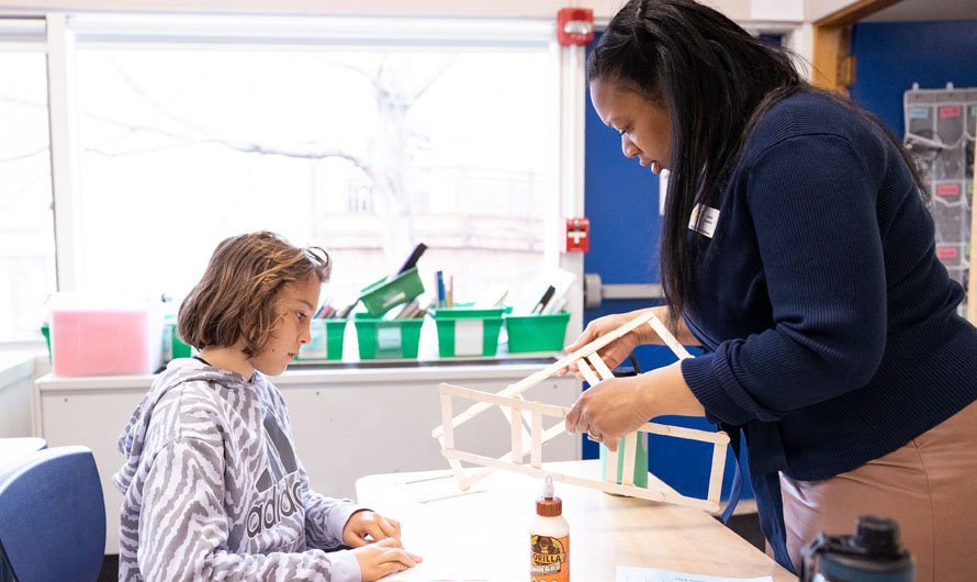 teacher with student in classroom