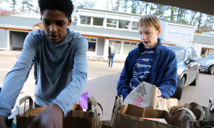 boys holding paper bags