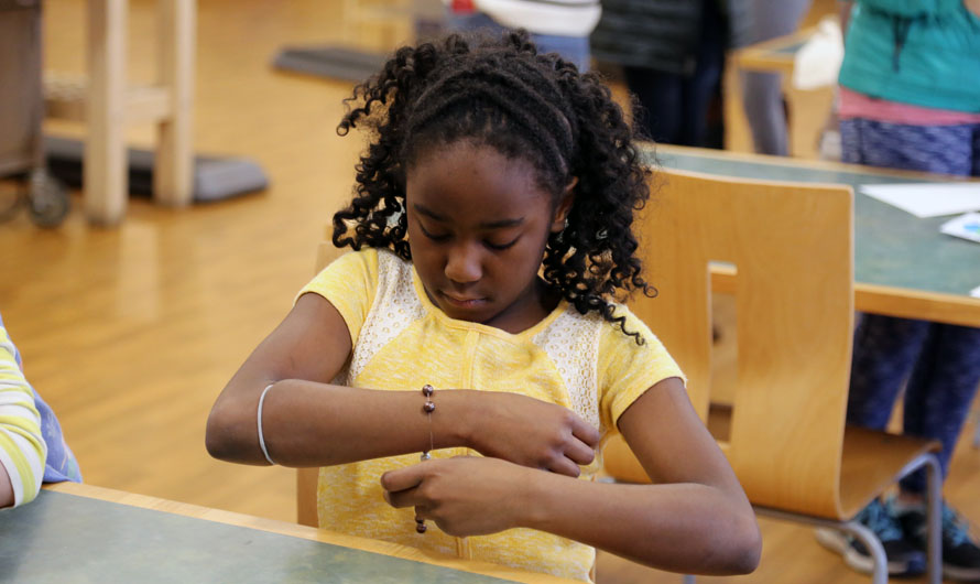 girl putting on a bracelet