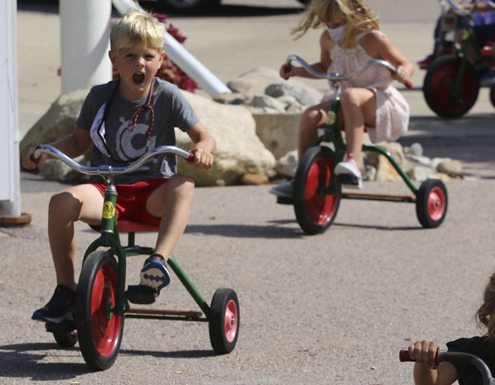 boy riding tricyle