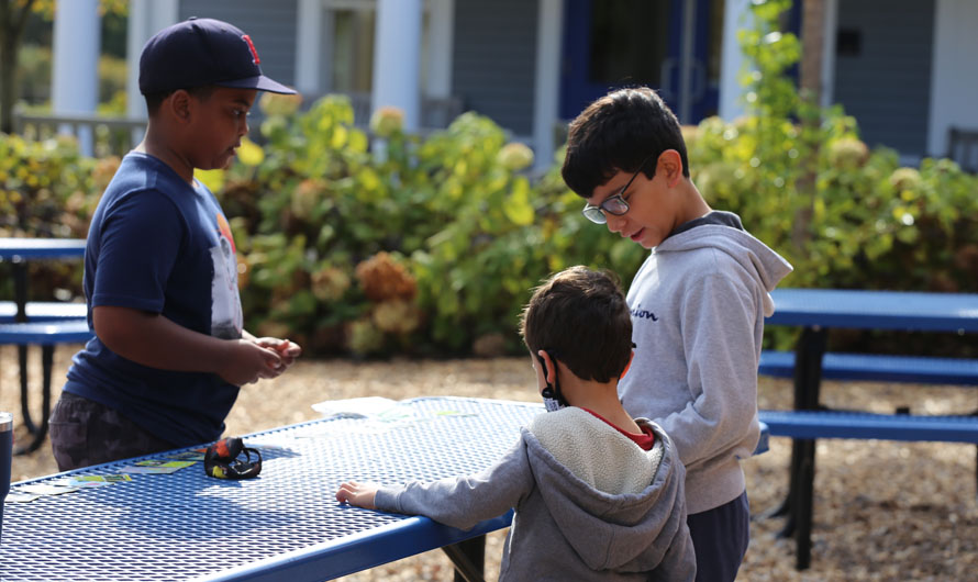 boys sitting at a picnic table