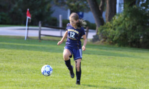 girl playing soccer 