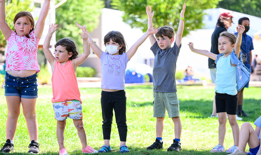 children raising their arms