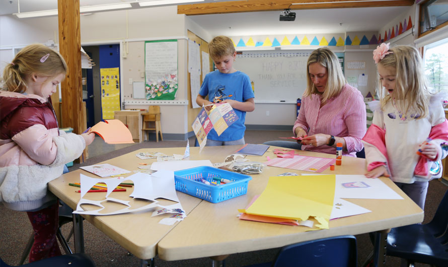 adults and children doing arts and crafts