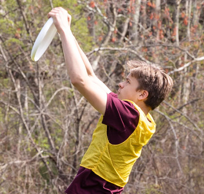 Boy catching Frisbee