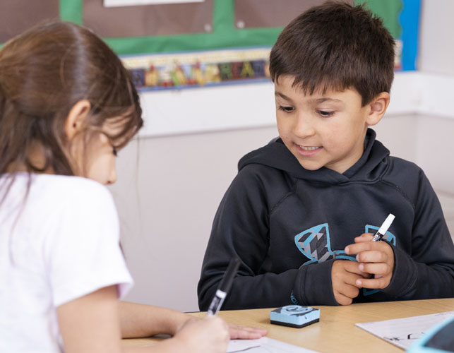 Students at a desk together