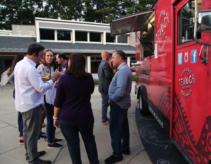 Adults standing by food truck