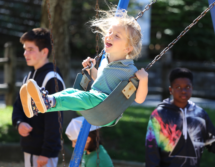 boy laughing on swing