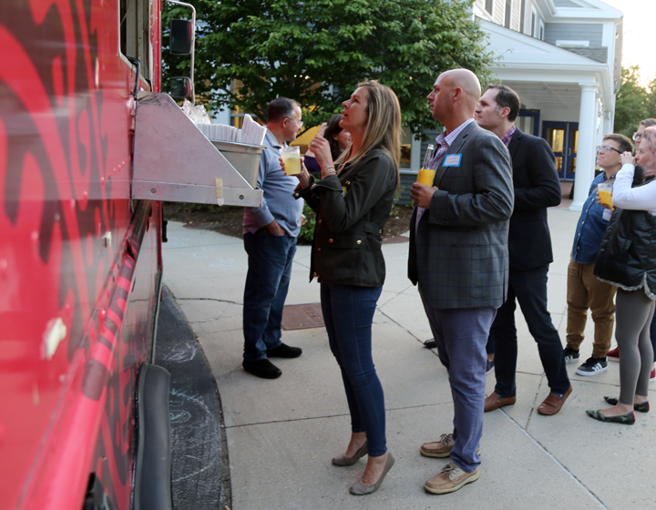 Adults ordering food at taco truck