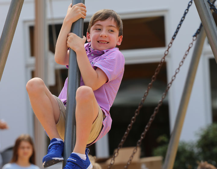 boy on playground equipment