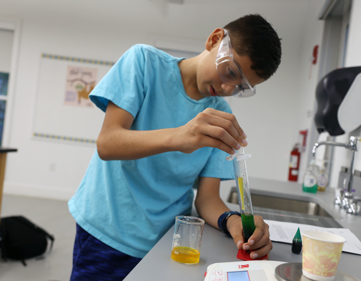boy with science beaker