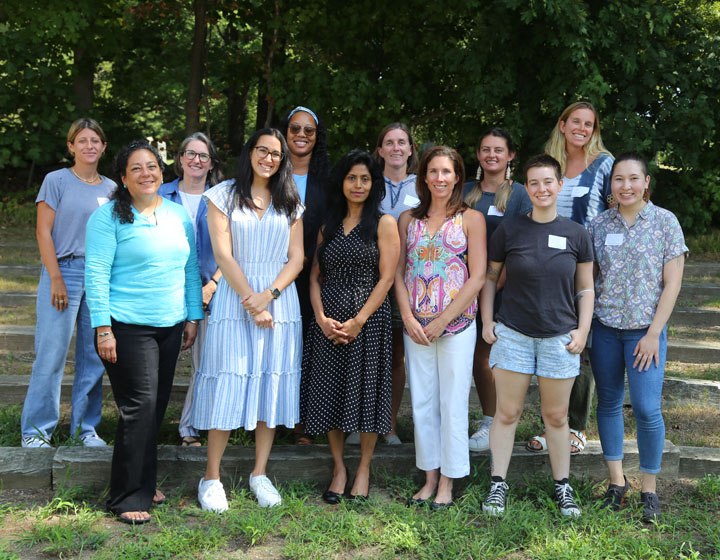 Group of adults posing for photo outside