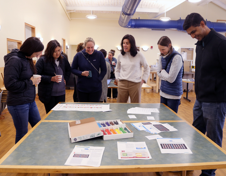 Adults at activity table discussing math