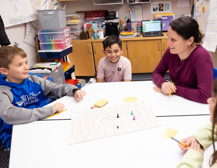 teacher with students at desk